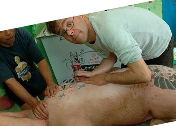 将猪洗干净，之后身上的毛剃光，开始再猪身上纹身。